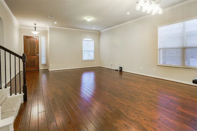 a view of a room with wooden floor and a window