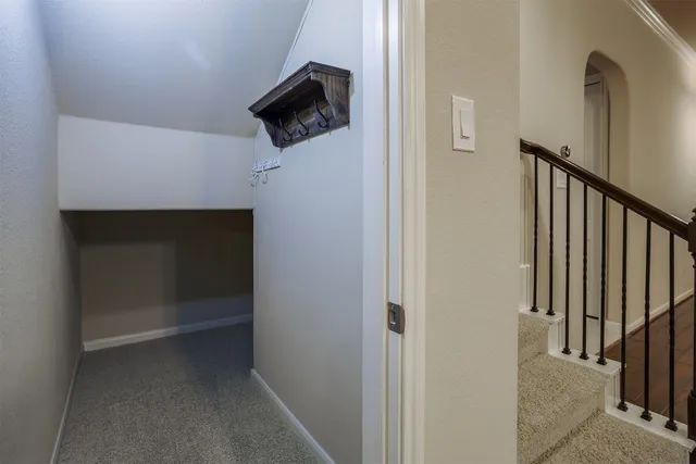 a view of a hallway with wooden floor and a cabinet