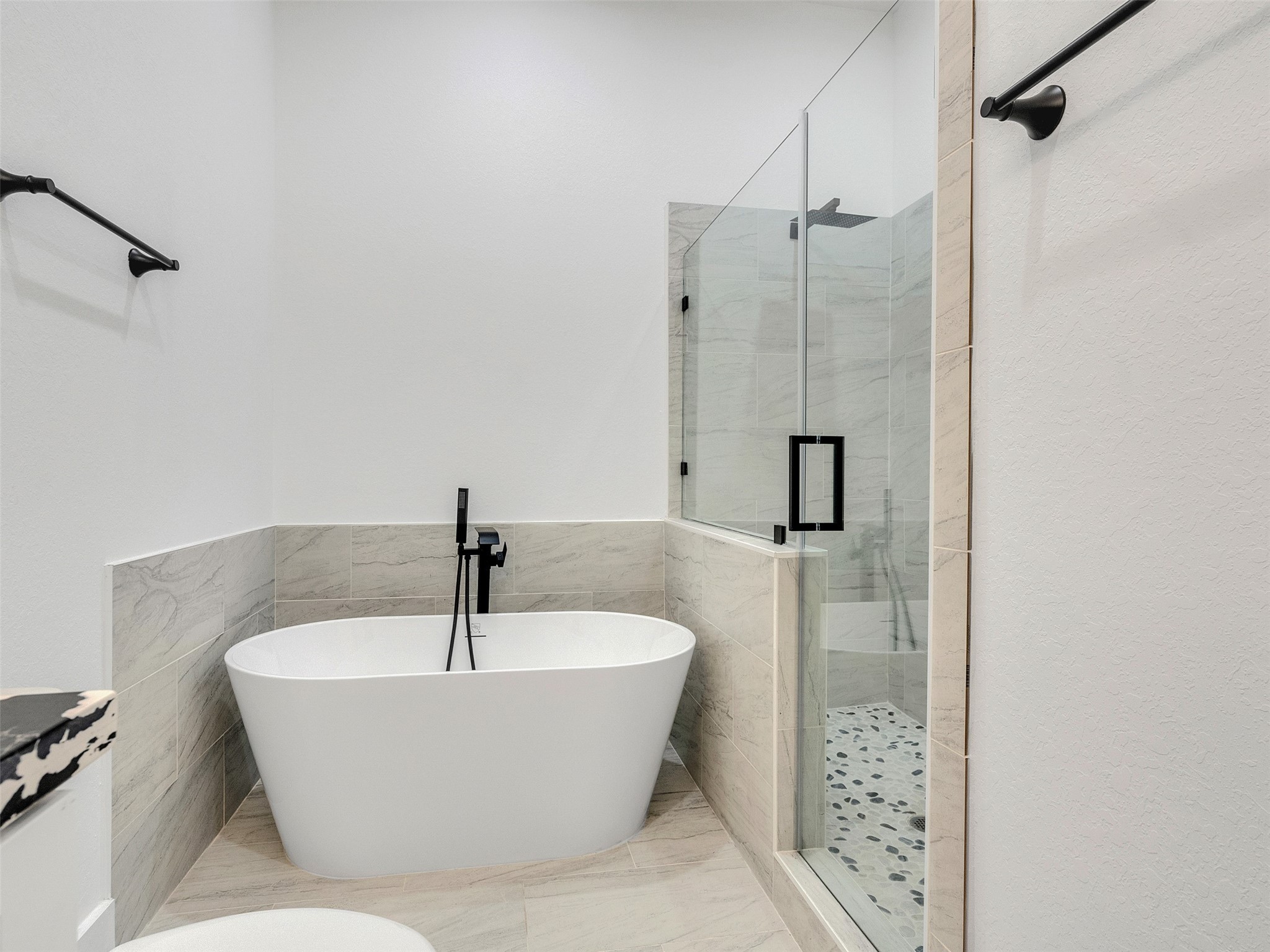 7358 Guadalcanal Road, Unit A Houston, TX 77033 - Photo 30 of 35 a bathroom with a bathtub and shower