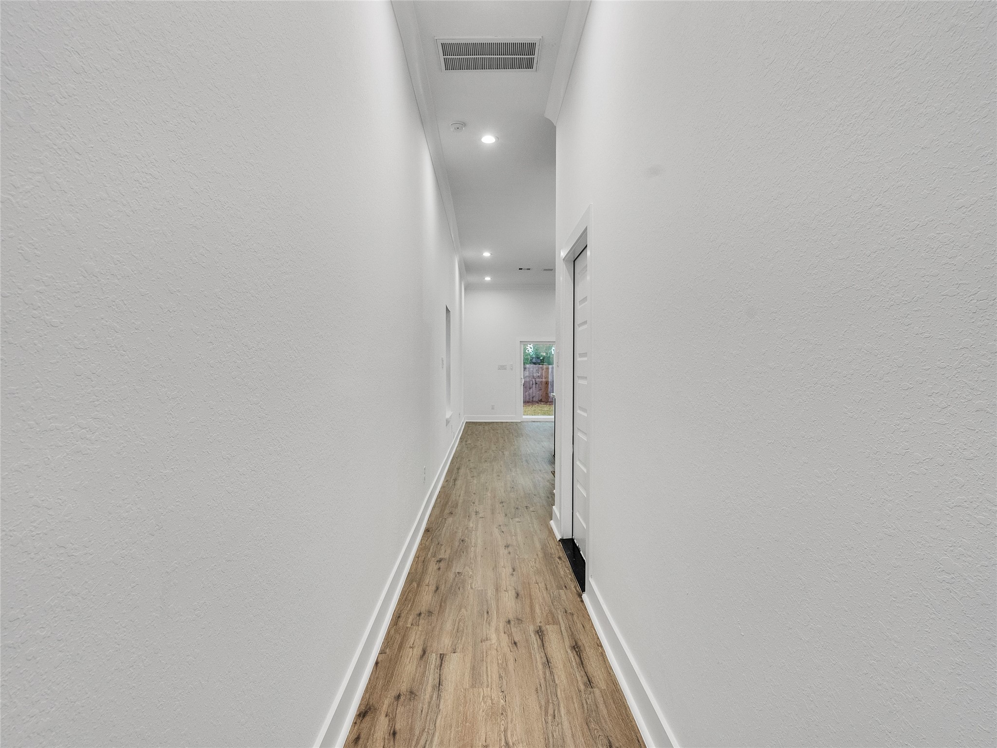 7358 Guadalcanal Road, Unit A Houston, TX 77033 - Photo 5 of 35 a view of a hallway with wooden floor