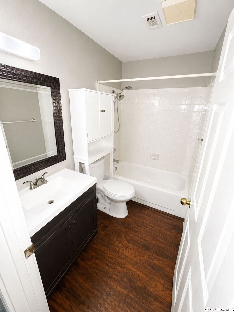 11610 Vance Jackson Road, Unit 867 San Antonio, TX 78230 - Photo 10 of 10 a bathroom with a sink a toilet a mirror and shower