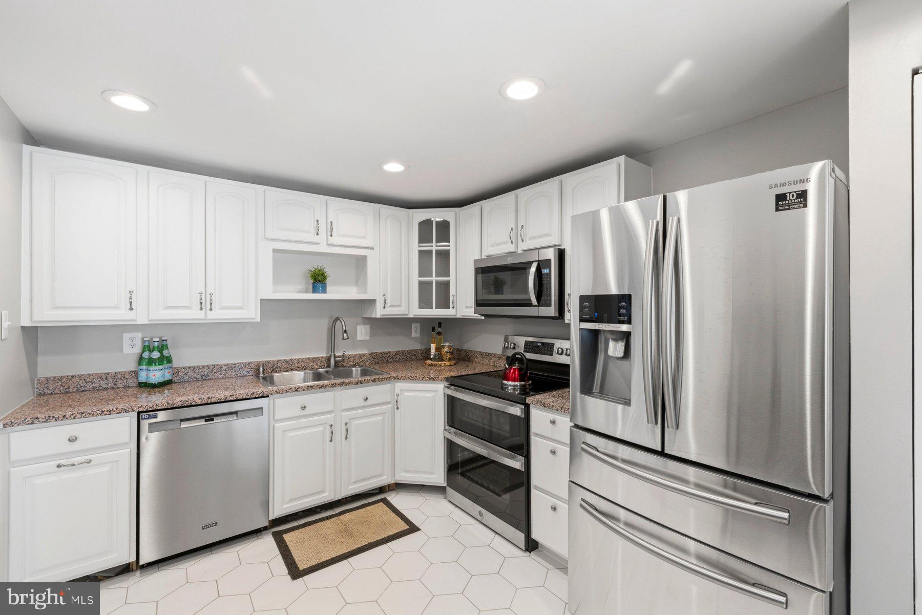 5 Pontiac Way Gaithersburg, MD 20878 - Photo 14 of 40 a kitchen with white cabinets stainless steel appliances and a window