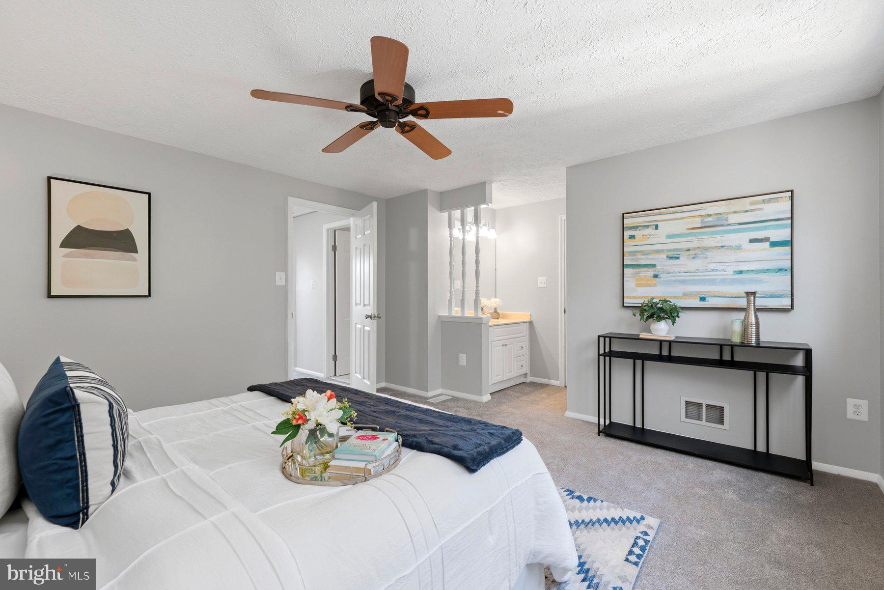5 Pontiac Way Gaithersburg, MD 20878 - Photo 16 of 40 a bedroom with a bed a chandelier and a mirror