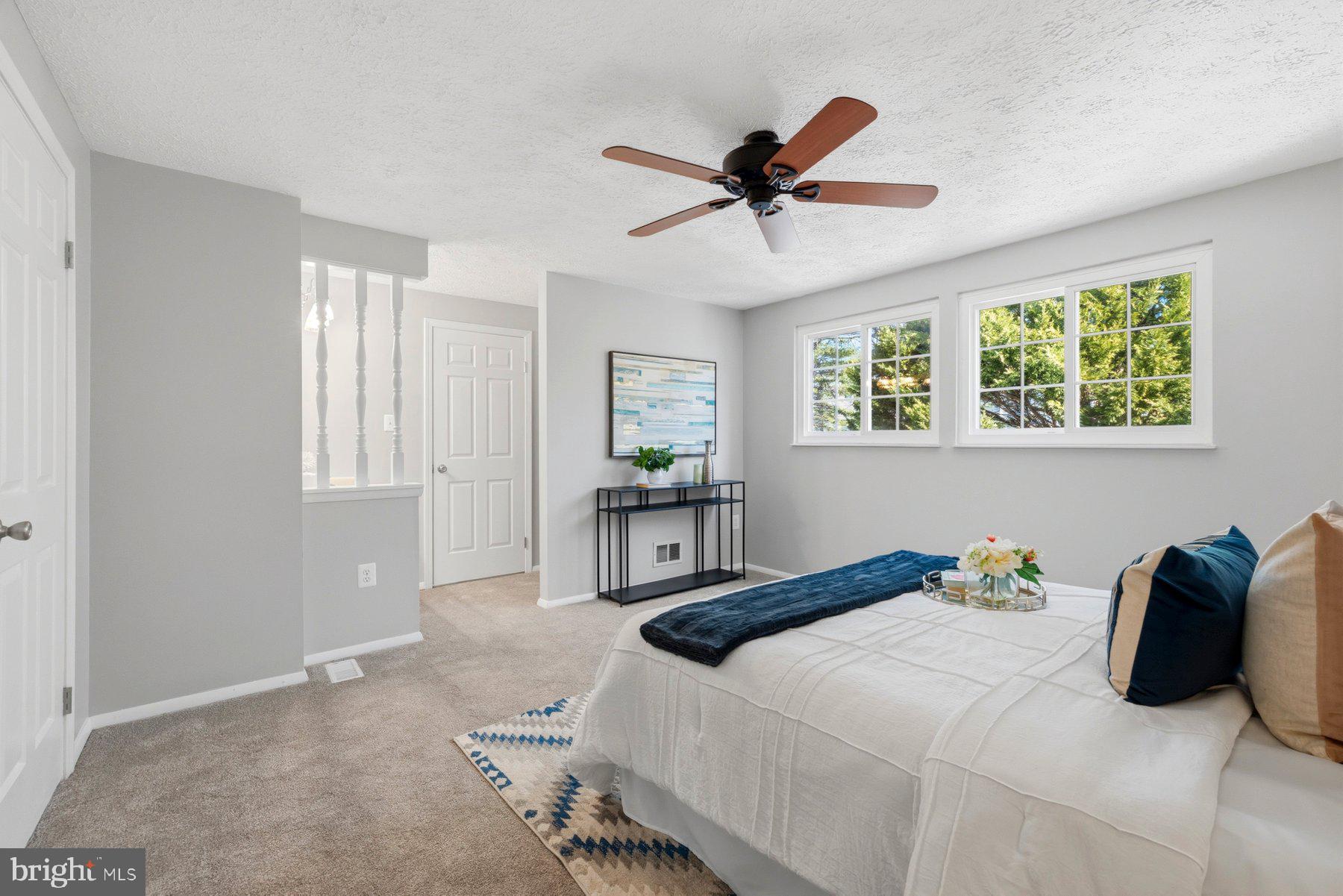 5 Pontiac Way Gaithersburg, MD 20878 - Photo 17 of 40 a bedroom with a large bed and a chandelier