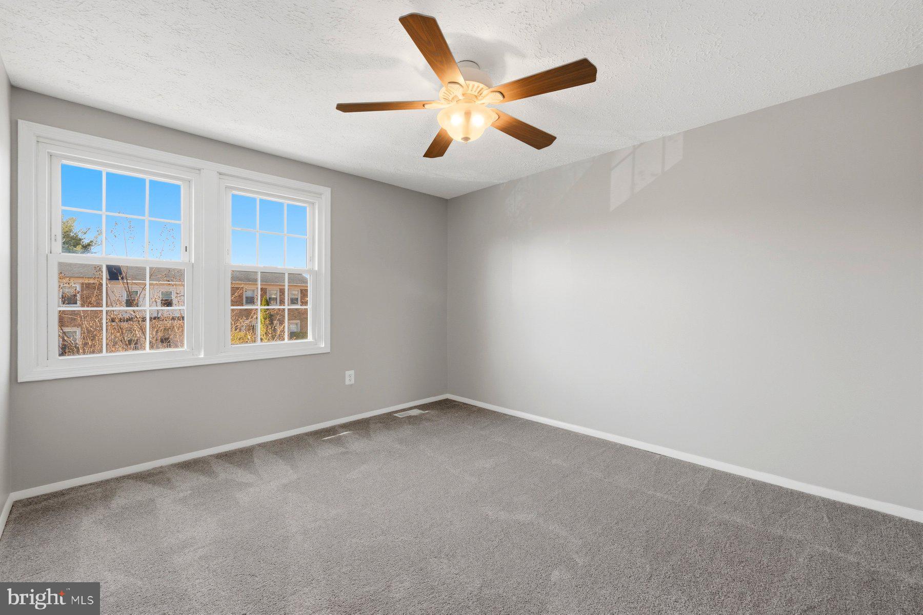 5 Pontiac Way Gaithersburg, MD 20878 - Photo 21 of 40 an empty room with ceiling fan and windows