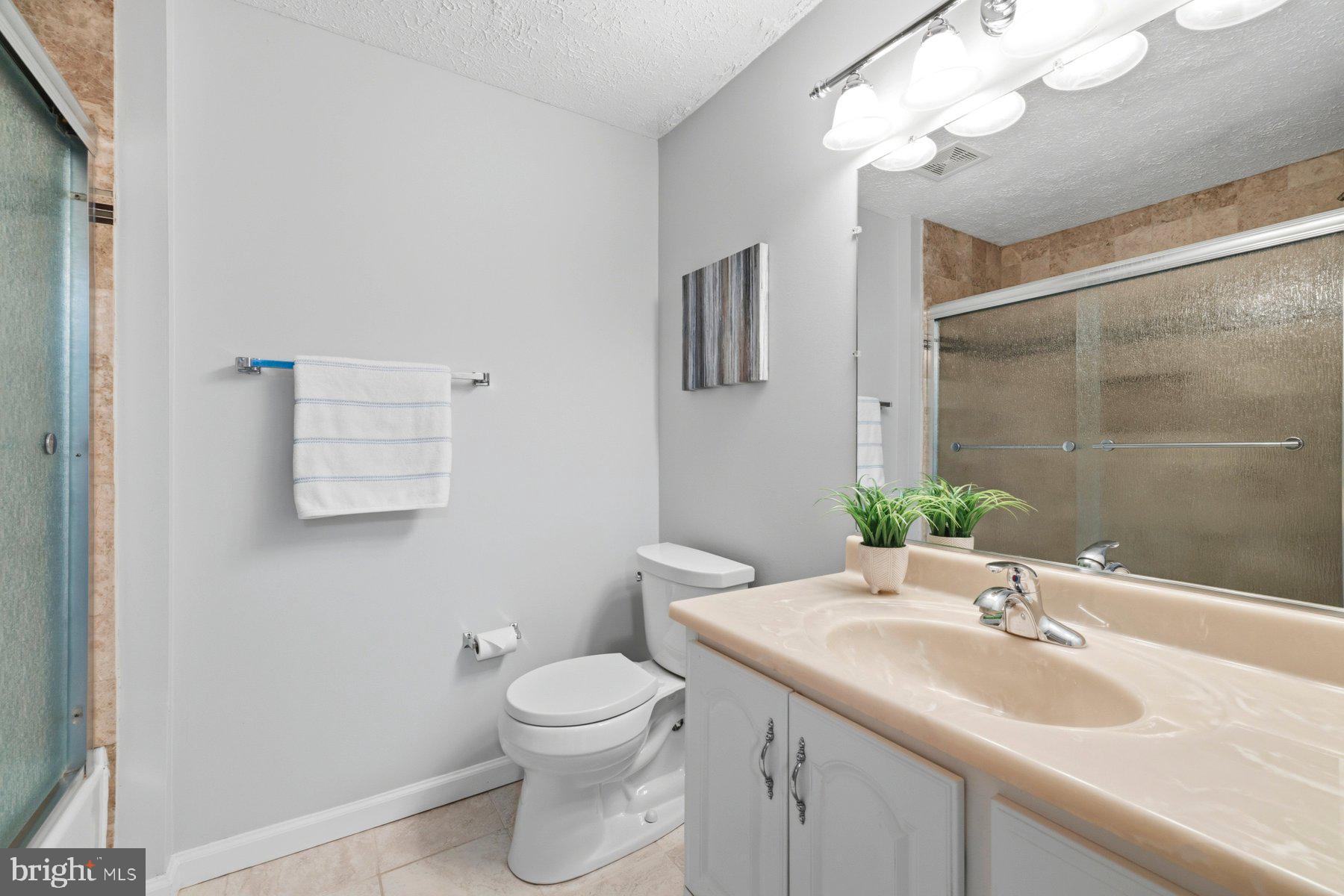 5 Pontiac Way Gaithersburg, MD 20878 - Photo 24 of 40 a bathroom with a granite countertop sink a toilet and a mirror