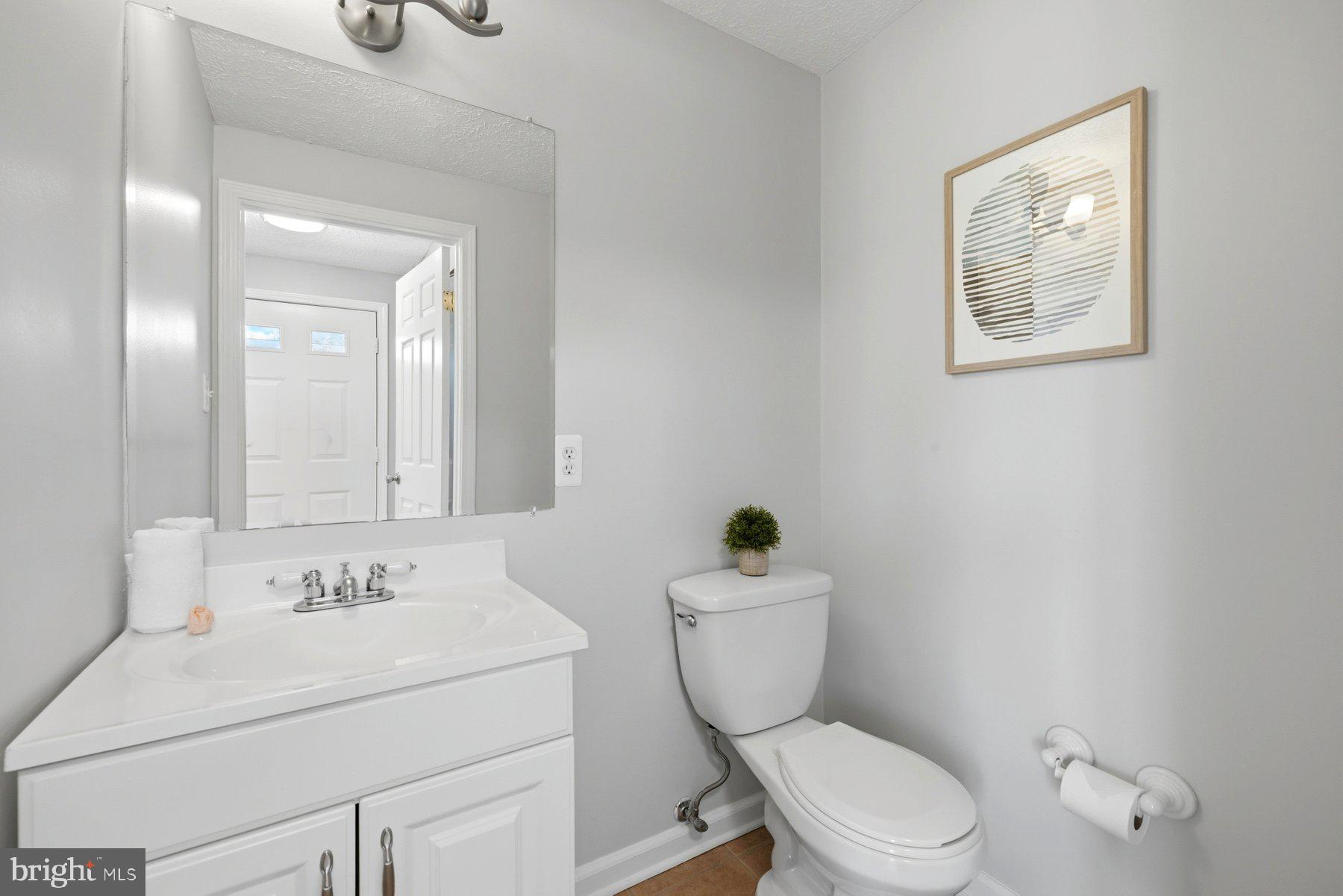 5 Pontiac Way Gaithersburg, MD 20878 - Photo 7 of 40 a bathroom with a toilet sink vanity and mirror