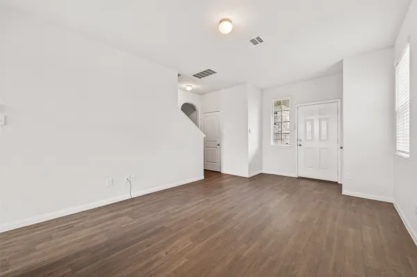 a kitchen with a refrigerator and a stove top oven