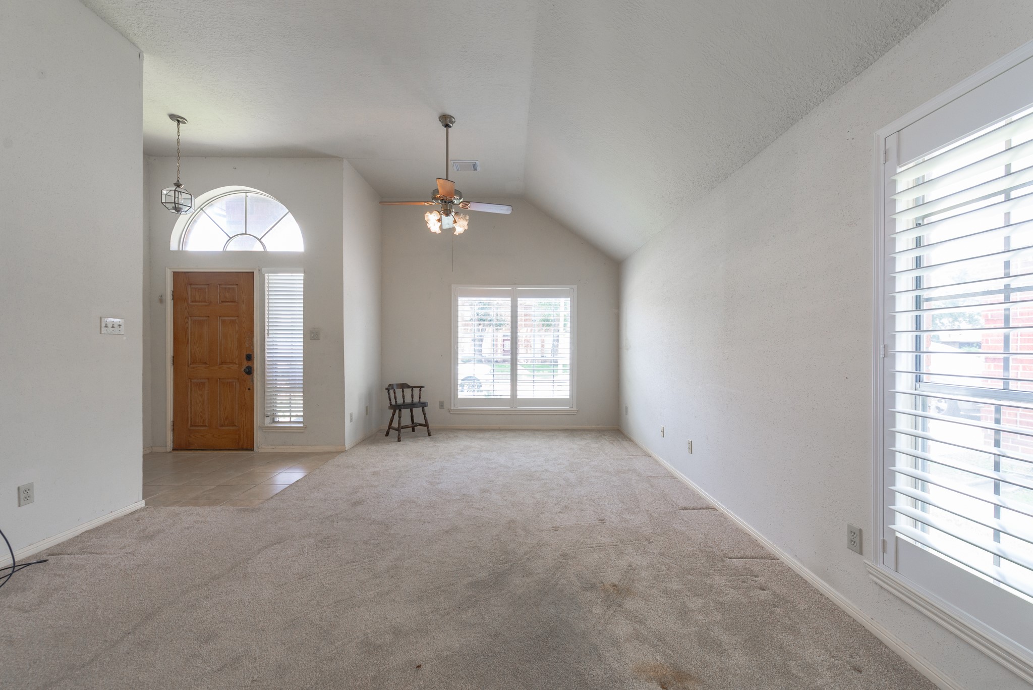 12203 Canterhurst Way Houston, TX 77065 - Photo 5 of 23 an empty room that has a window in it