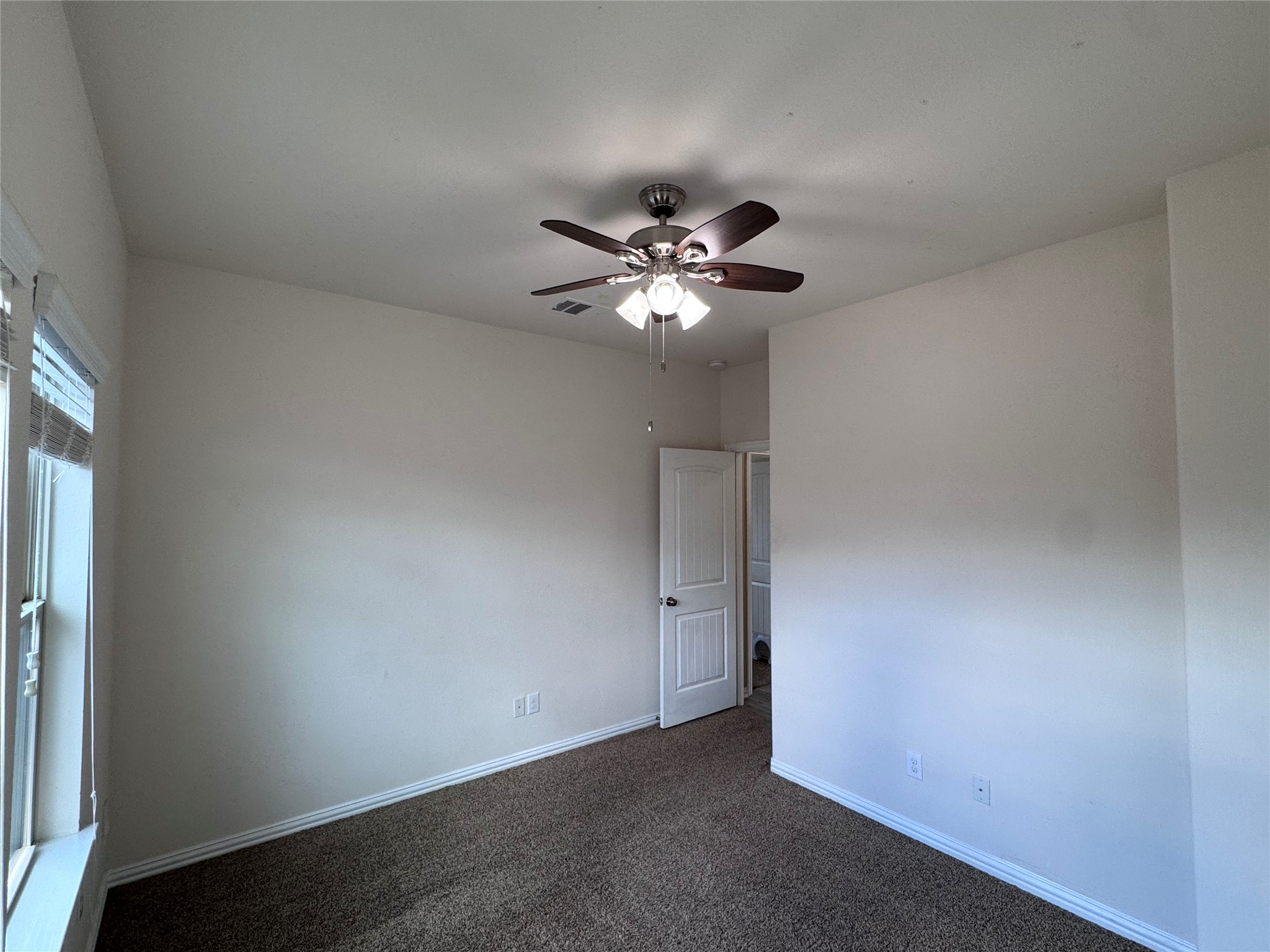2605 Rough Berry Road Pflugerville, TX 78660 - Photo 25 of 40 A comfortable bedroom with soft carpet and a cooling ceiling fan awaits its next resident.