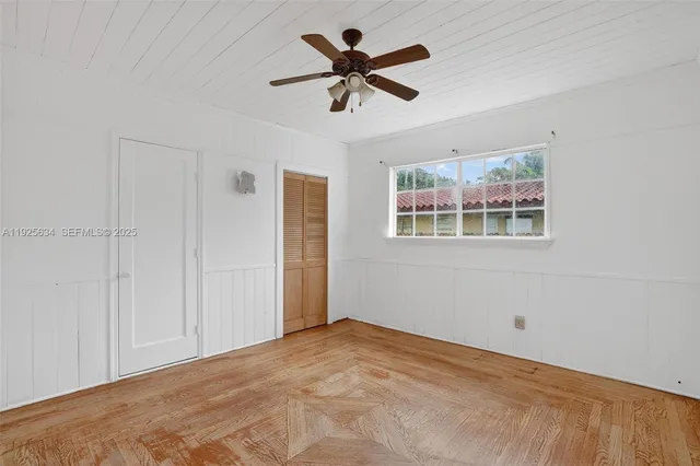 a view of empty room with wooden floor