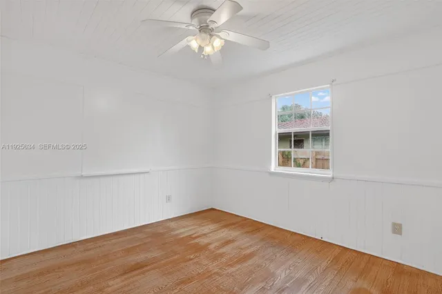 a view of a room with an empty space and a ceiling fan