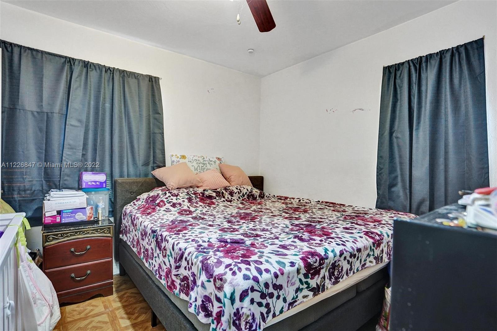 1554 Northwest 58th Street Miami, FL 33142 - Photo 11 of 57 a bedroom with a bed and a dresser in it