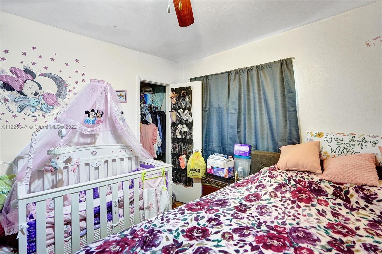 1554 Northwest 58th Street Miami, FL 33142 - Photo 13 of 57 a bedroom with baby bed and a window