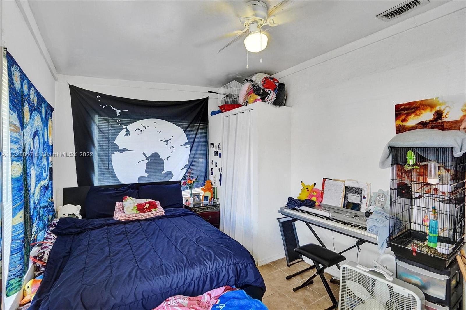 1554 Northwest 58th Street Miami, FL 33142 - Photo 14 of 57 a bedroom with a bed and furniture