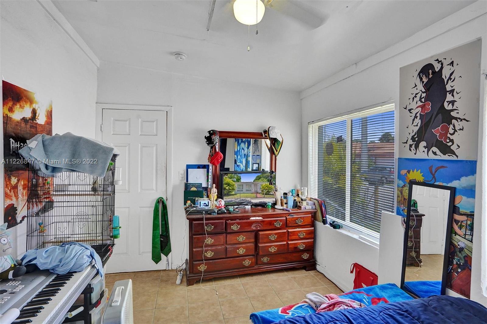 1554 Northwest 58th Street Miami, FL 33142 - Photo 16 of 57 a bed room with furniture and a window