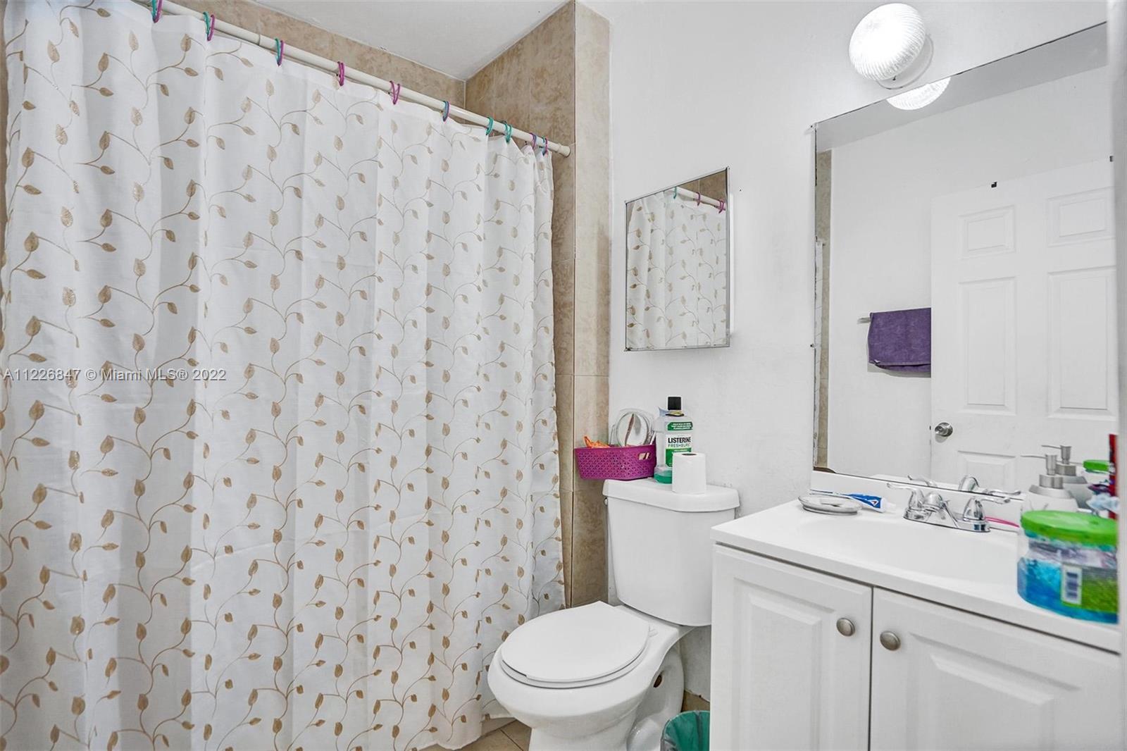 1554 Northwest 58th Street Miami, FL 33142 - Photo 19 of 57 a bathroom with a sink toilet and a mirror