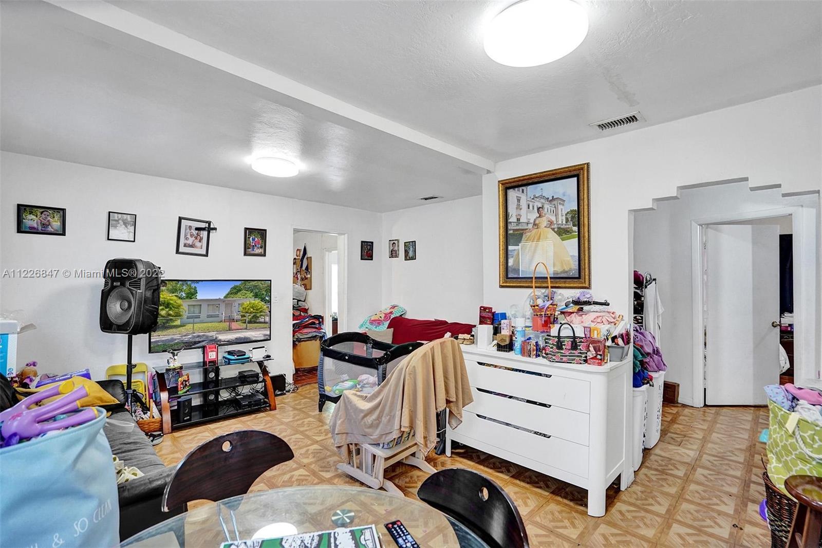 1554 Northwest 58th Street Miami, FL 33142 - Photo 20 of 57 a bedroom with furniture a flat screen tv and a window