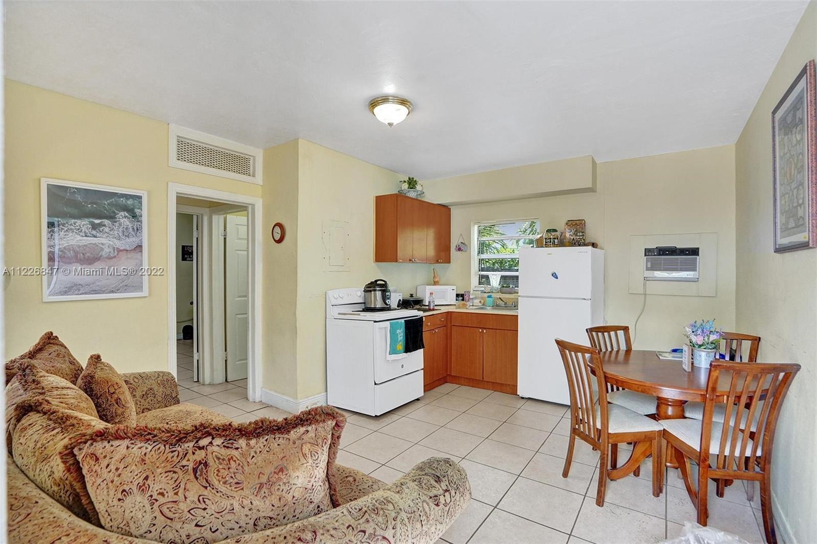 1554 Northwest 58th Street Miami, FL 33142 - Photo 25 of 57 a living room with furniture and kitchen view