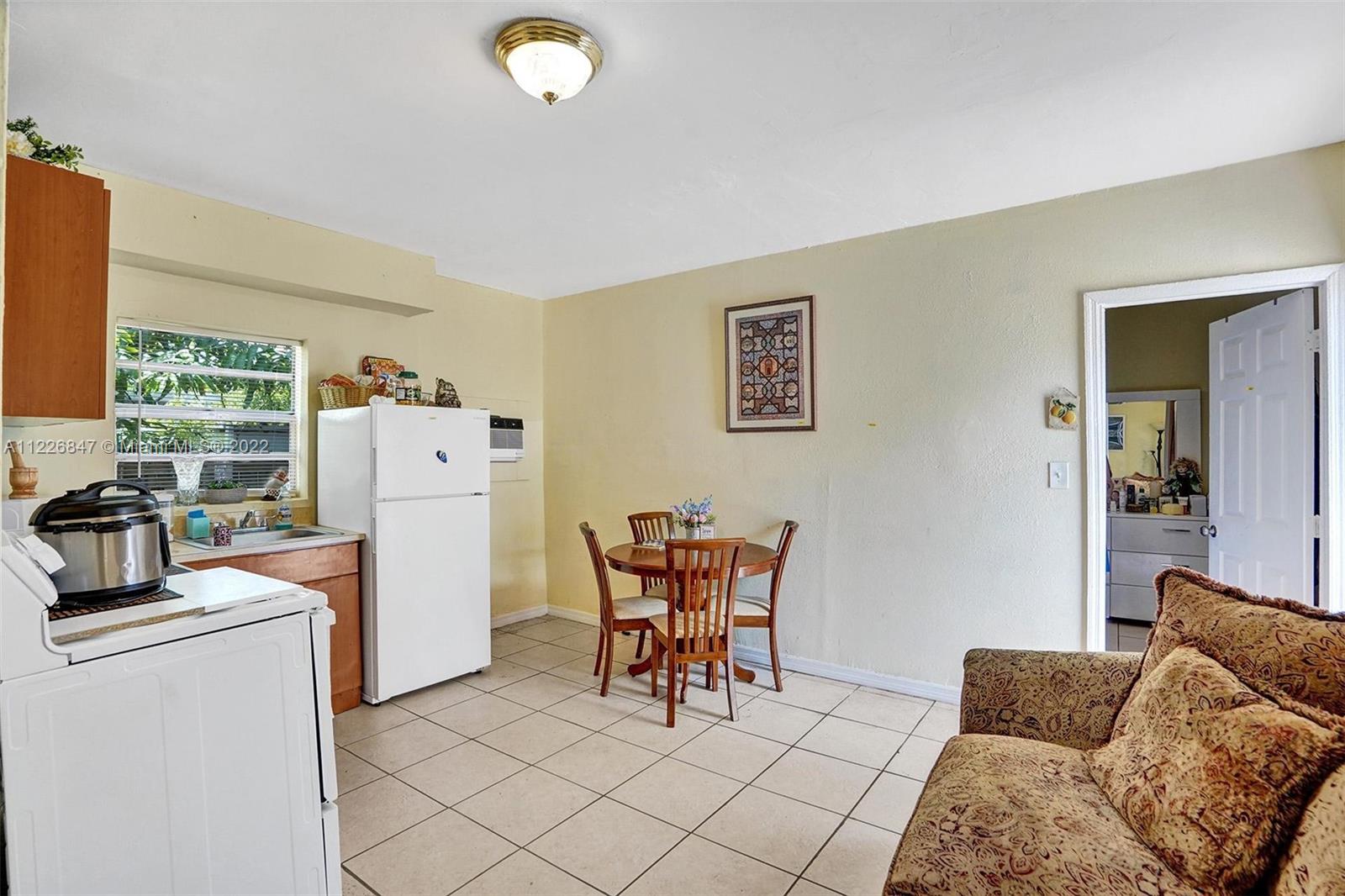 1554 Northwest 58th Street Miami, FL 33142 - Photo 26 of 57 a work room with furniture and a flat screen tv