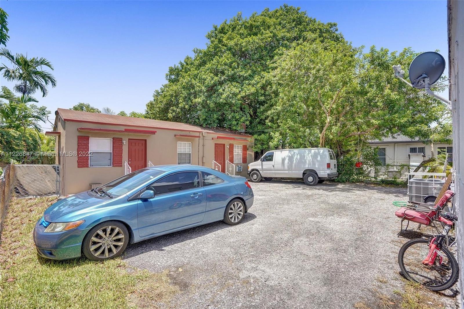 1554 Northwest 58th Street Miami, FL 33142 - Photo 36 of 57 a car parked in front of a house