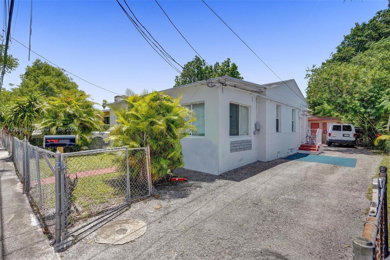 1554 Northwest 58th Street Miami, FL 33142 - Photo 41 of 57 a front view of a house with a yard