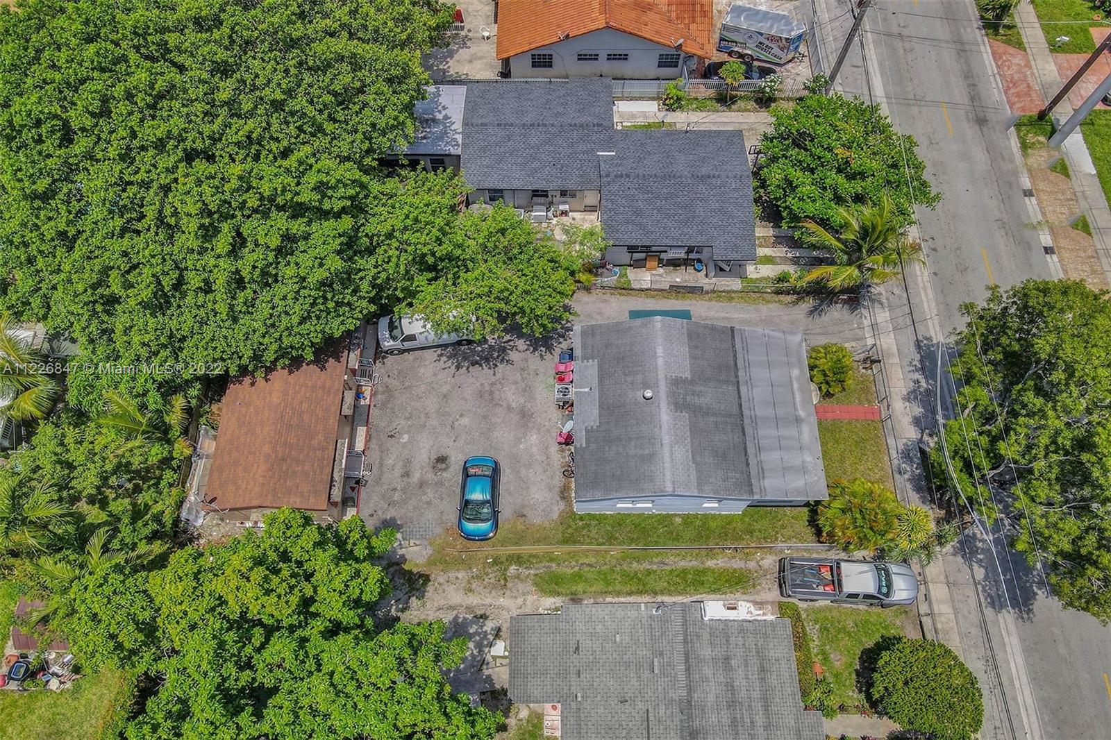 1554 Northwest 58th Street Miami, FL 33142 - Photo 48 of 57 an aerial view of a house with garden space and a building