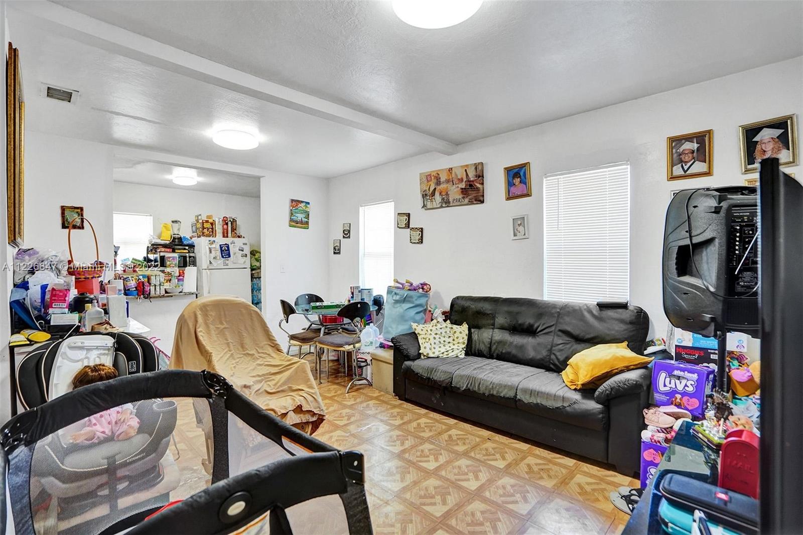 1554 Northwest 58th Street Miami, FL 33142 - Photo 5 of 57 a living room with furniture and a flat screen tv