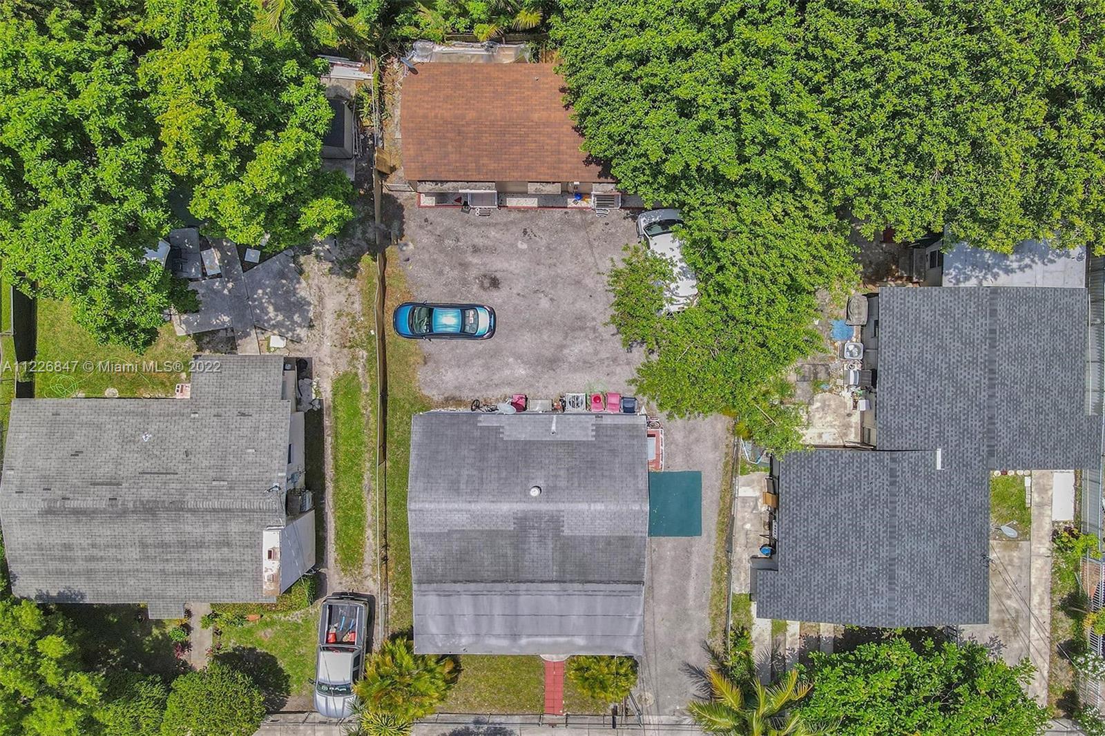 1554 Northwest 58th Street Miami, FL 33142 - Photo 53 of 57 aerial view of a house with a yard and a large tree