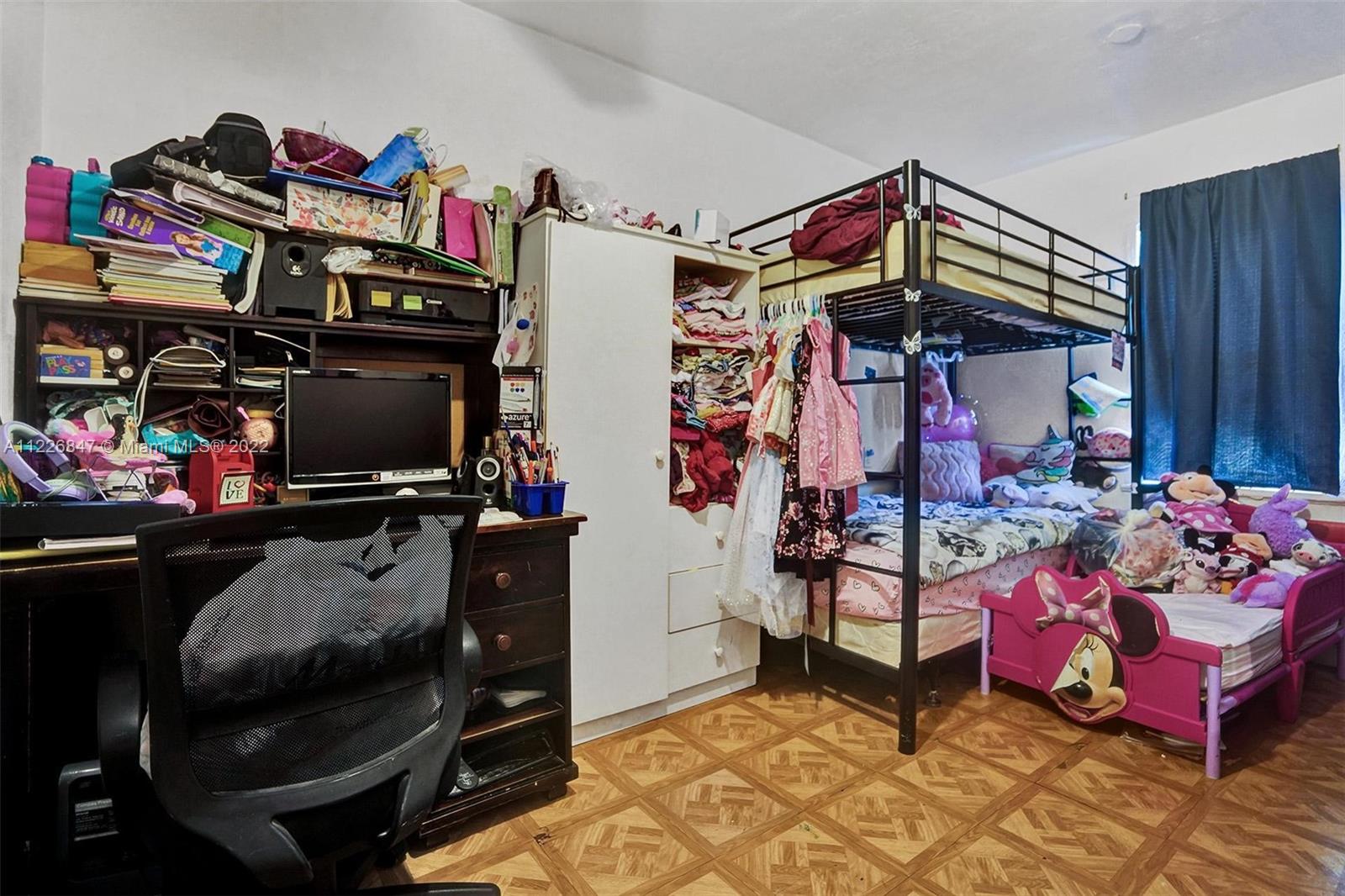 1554 Northwest 58th Street Miami, FL 33142 - Photo 8 of 57 a bedroom with furniture and a flat screen tv