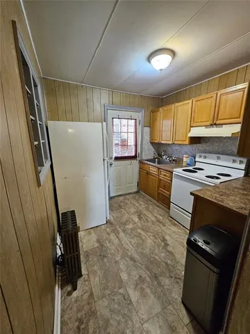 a kitchen with a refrigerator stove and a sink