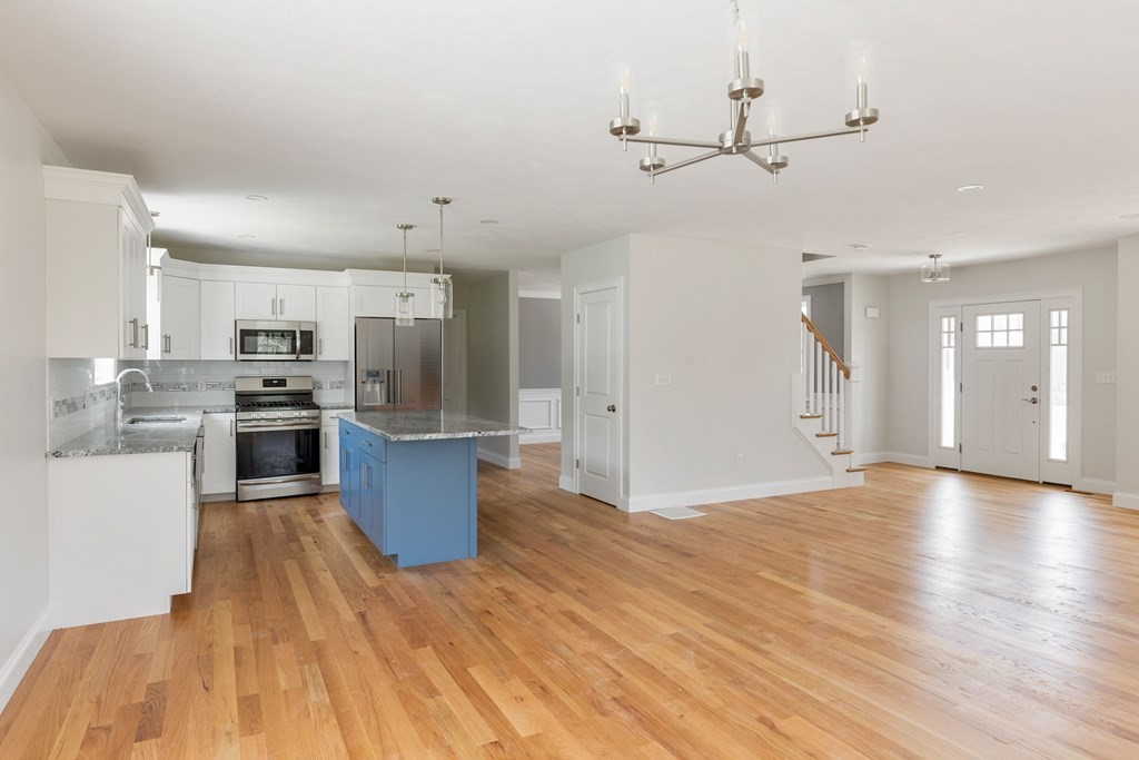 5 May Road Millis, MA 02054 - Photo 5 of 10 a view of kitchen with cabinets stainless steel appliances and wooden floor