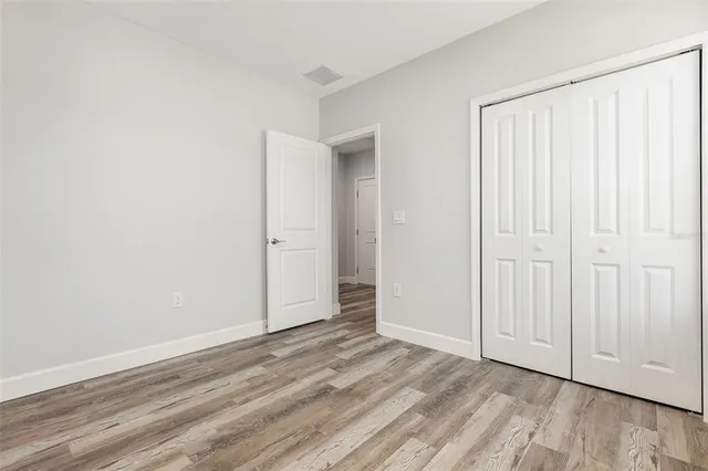 an empty room with wooden floor