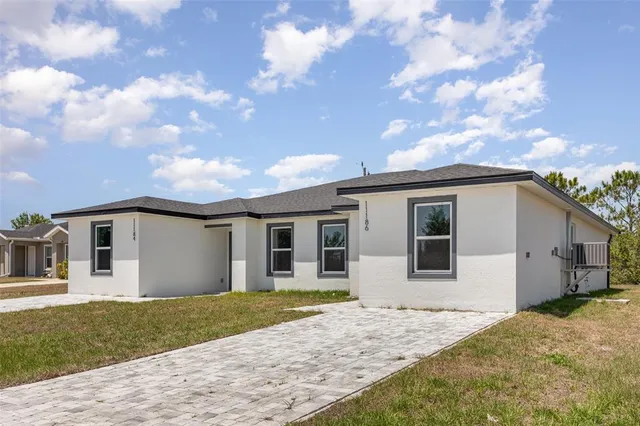 a view of a house with a backyard