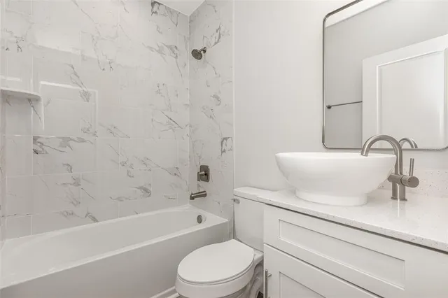 a bathroom with a sink a toilet and a bathtub