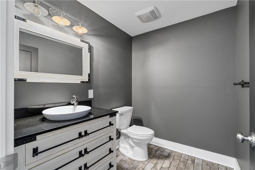 570 Steiner Bridge Road Valencia, PA 16059 - Photo 21 of 35 a bathroom with a toilet a sink and a mirror