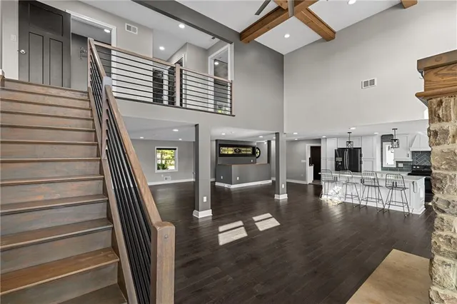 a view of a livingroom with fireplace wooden floor and windows