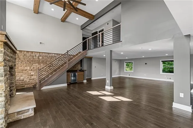 a large kitchen with granite countertop a stove top oven a sink a dining table and chairs