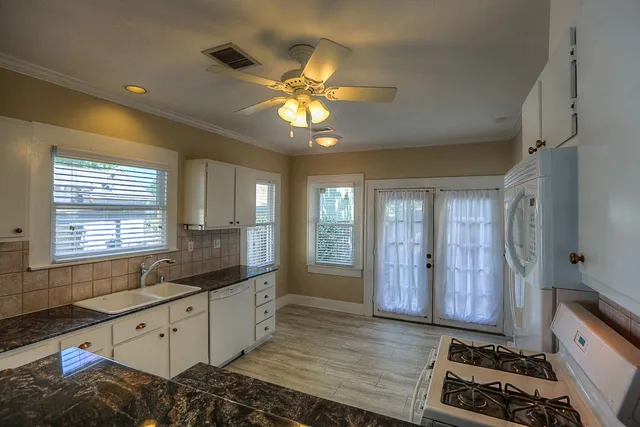 a kitchen with granite countertop a stove and a sink