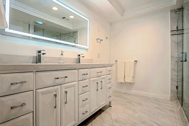 a bathroom with a double vanity sink and mirror