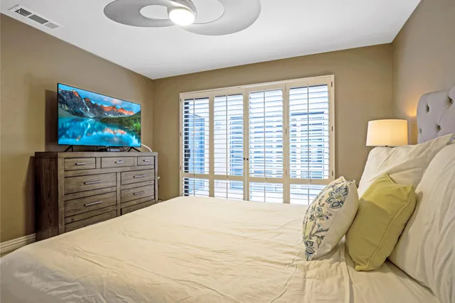 a bedroom with a bed and a television