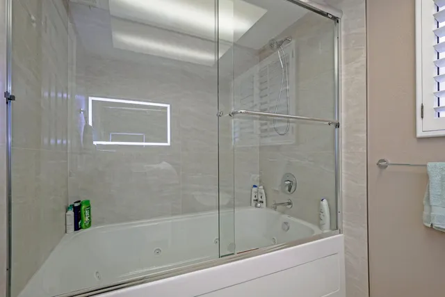 a bathroom with a bathtub and shower