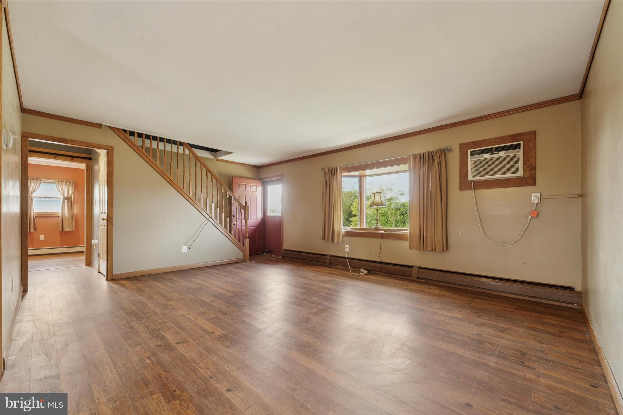 14 Cinnamon Road Levittown, PA 19057 - Photo 3 of 15 a view of an empty room with wooden floor and a window