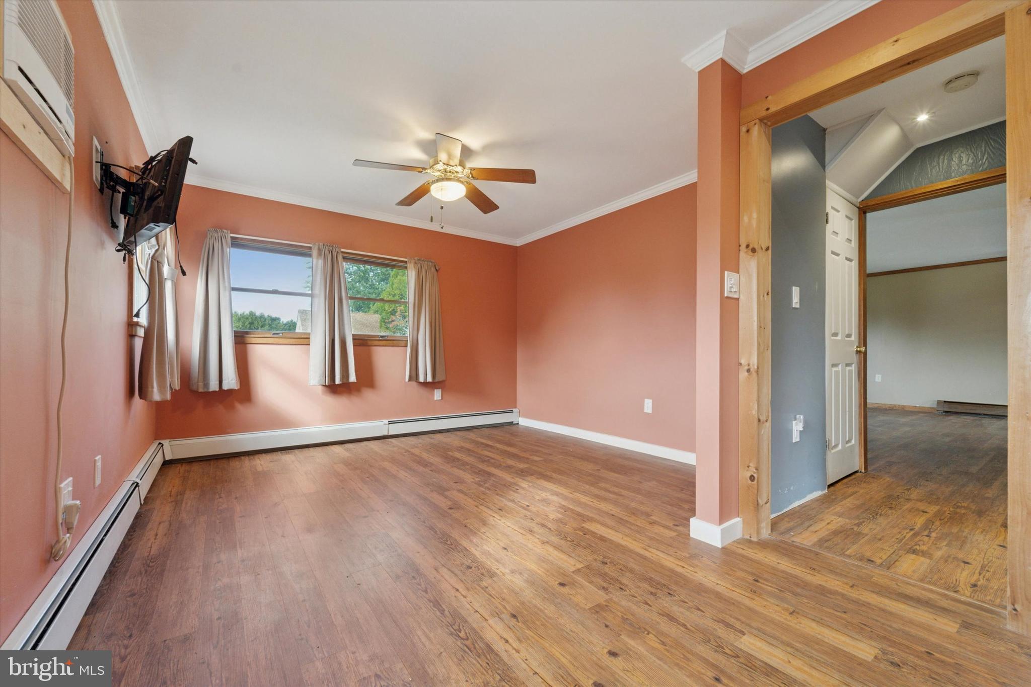 14 Cinnamon Road Levittown, PA 19057 - Photo 7 of 15 a view of an empty room with a window and wooden floor