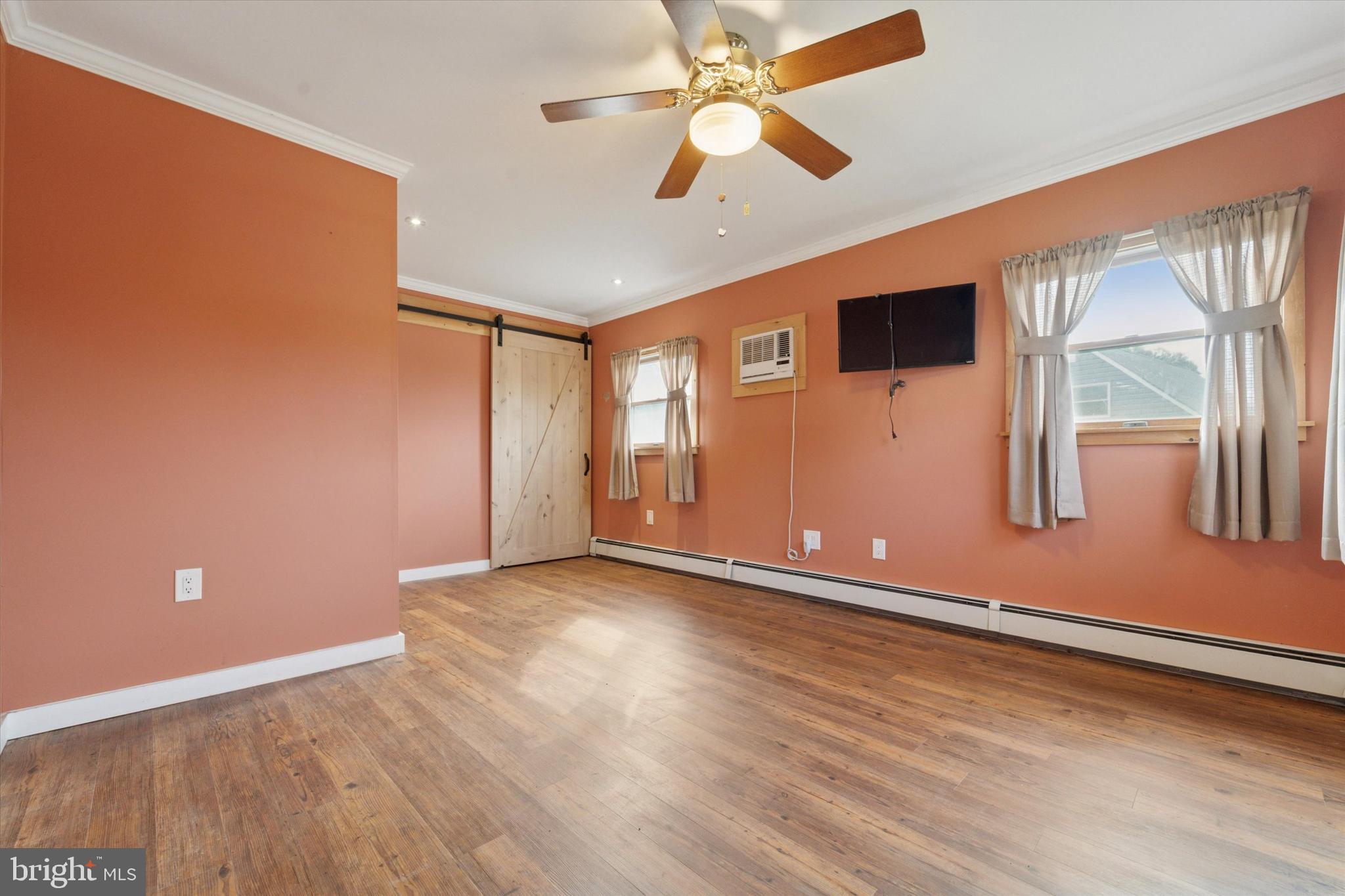 14 Cinnamon Road Levittown, PA 19057 - Photo 9 of 15 a view of an empty room with window and wooden floor