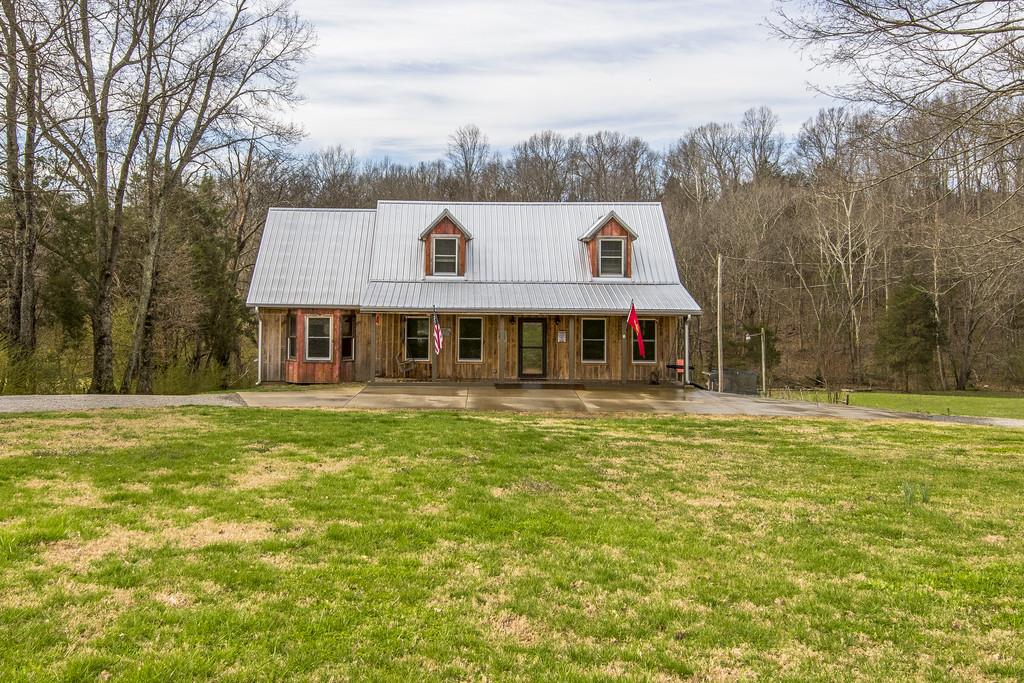 545 Haley Road Burns, TN 37029 - Photo 2 of 30 a front view of house with yard and trees in the background