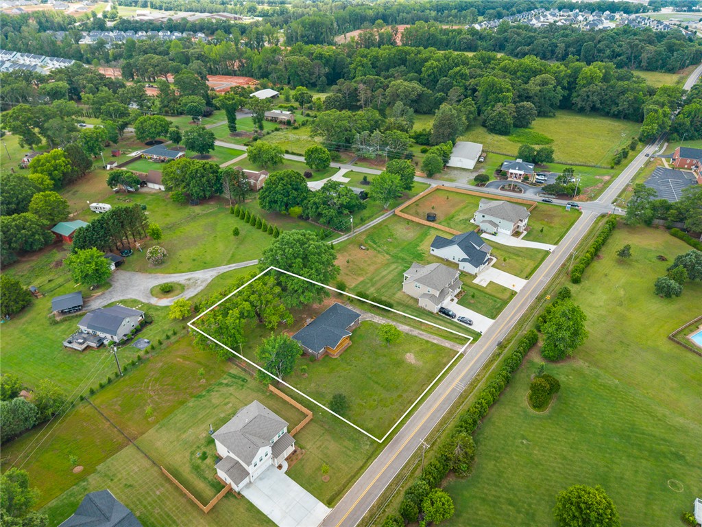 300 Vandiver Road Anderson, SC 29621 - Photo 26 of 30 An aerial perspective reveals a generous parcel of land nestled among verdant trees and residential streets.