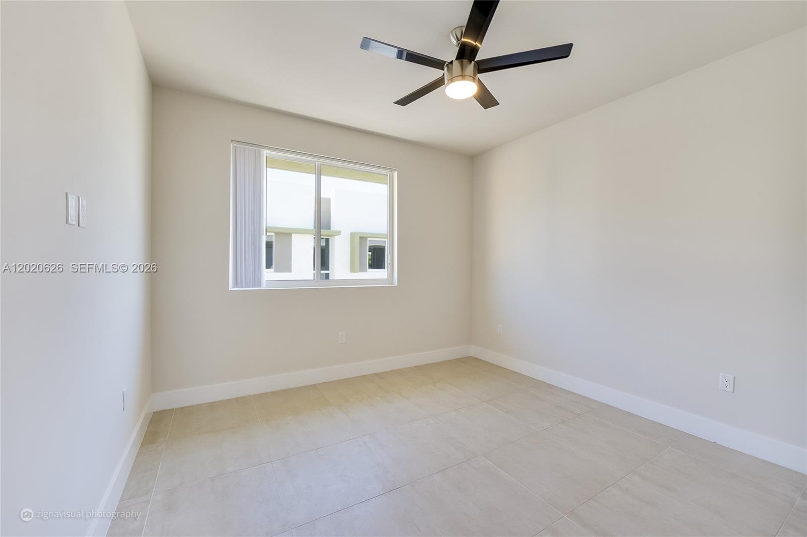 7701 Southwest 95th Terrace, Unit 1 Miami, FL 33156 - Photo 13 of 18 an empty room with a window and a fan