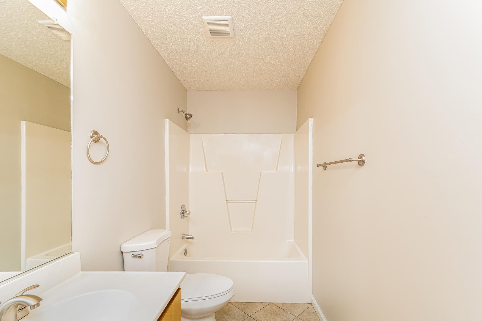 2100 McKinnon Drive Clayton, NC 27520 - Photo 16 of 17 a bathroom with a sink a toilet and shower