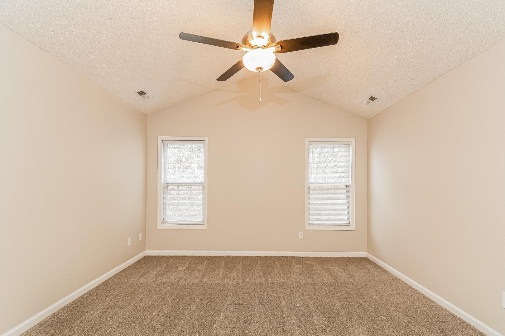 2100 McKinnon Drive Clayton, NC 27520 - Photo 7 of 17 an empty room with windows and fan